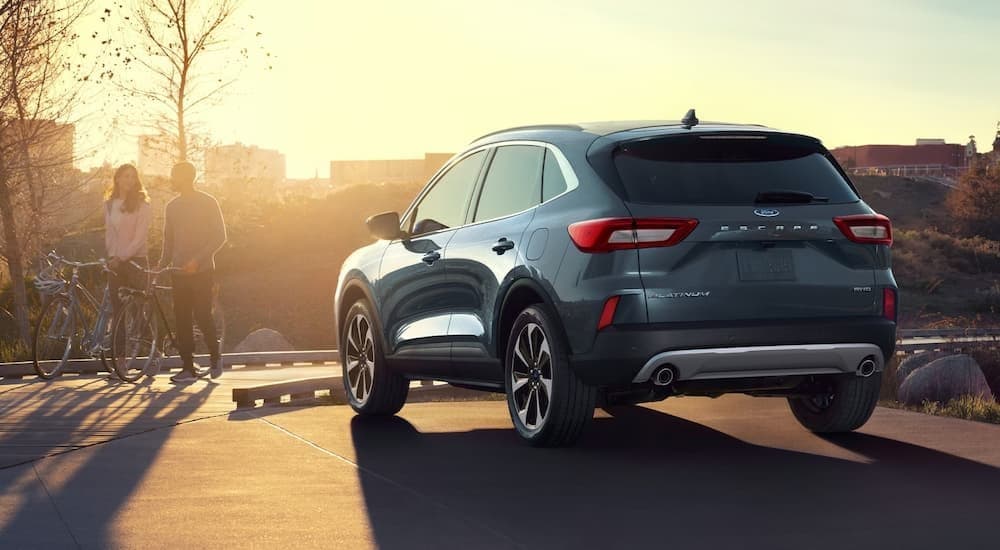 A blue 2024 Ford Escape Platinum parked at sunset.