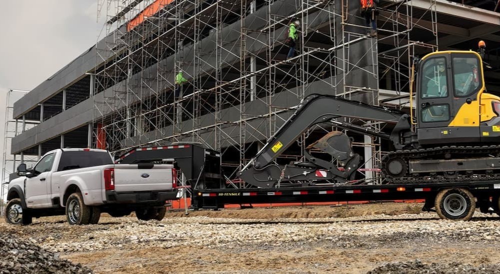 A white 2026 Ford F-450 towing a trailer.