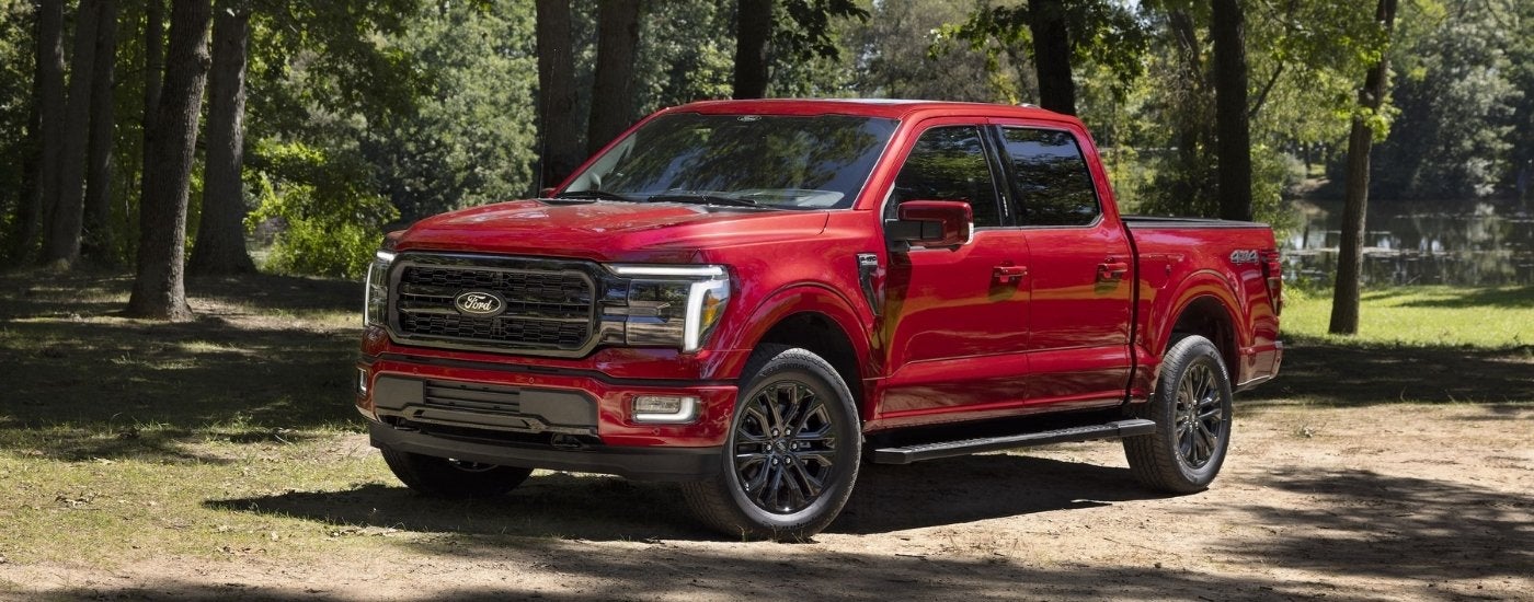 Red 2024 Ford F-150 parked by a lake