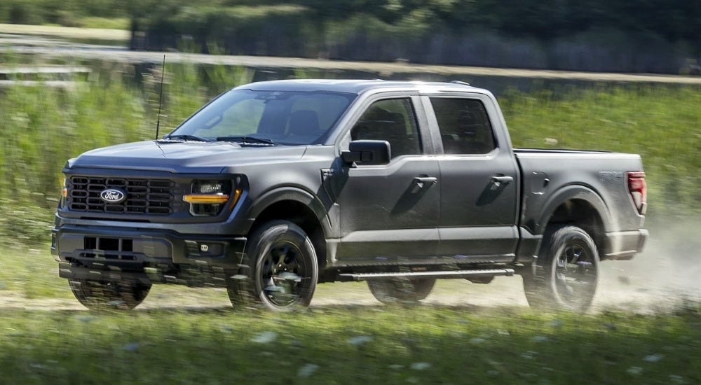 A gray 2024 Ford F-150 FX4 driving on a trail