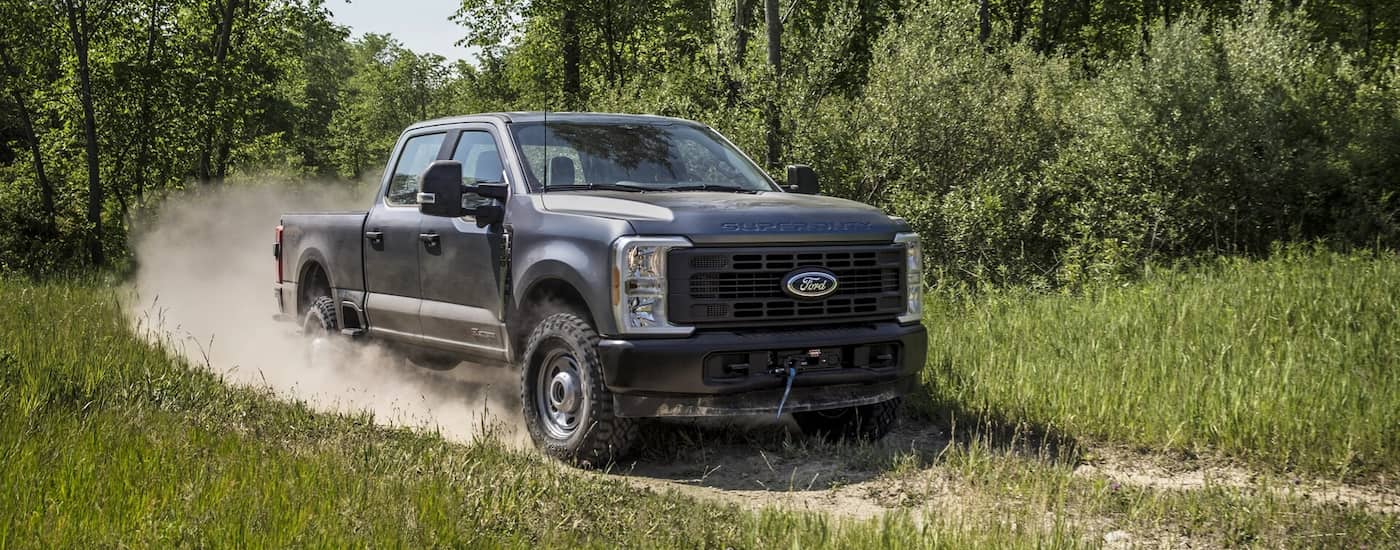 Grey 2025 Ford F-250 driving off-road.