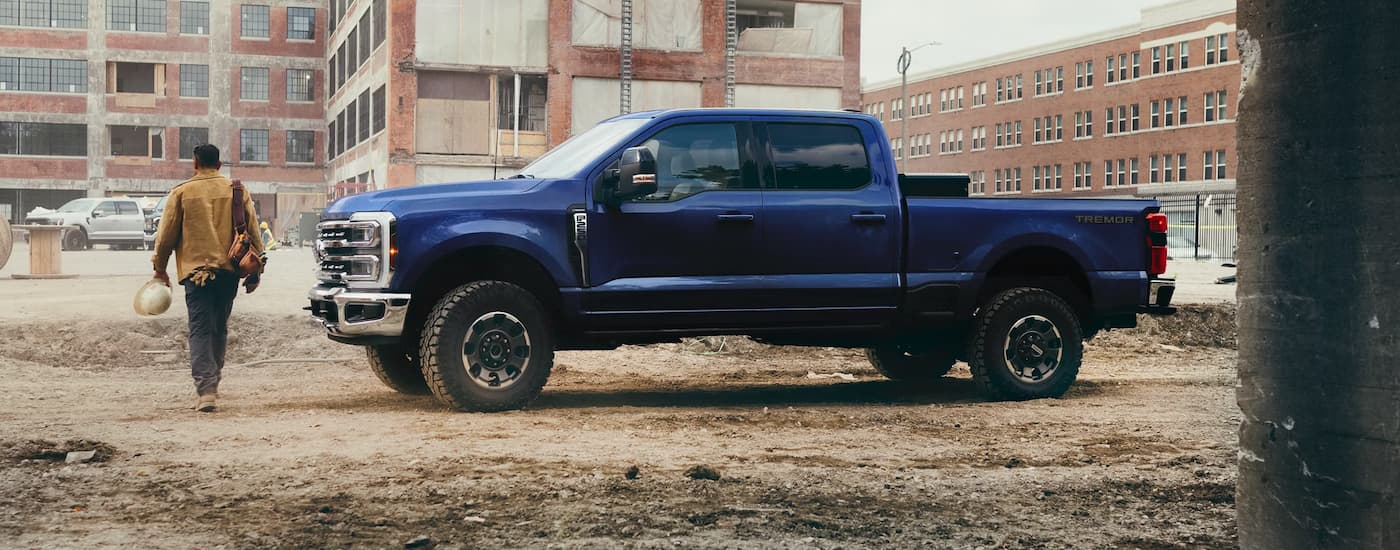 Blue 2026 Ford F-250 parked off-road at a construction site.