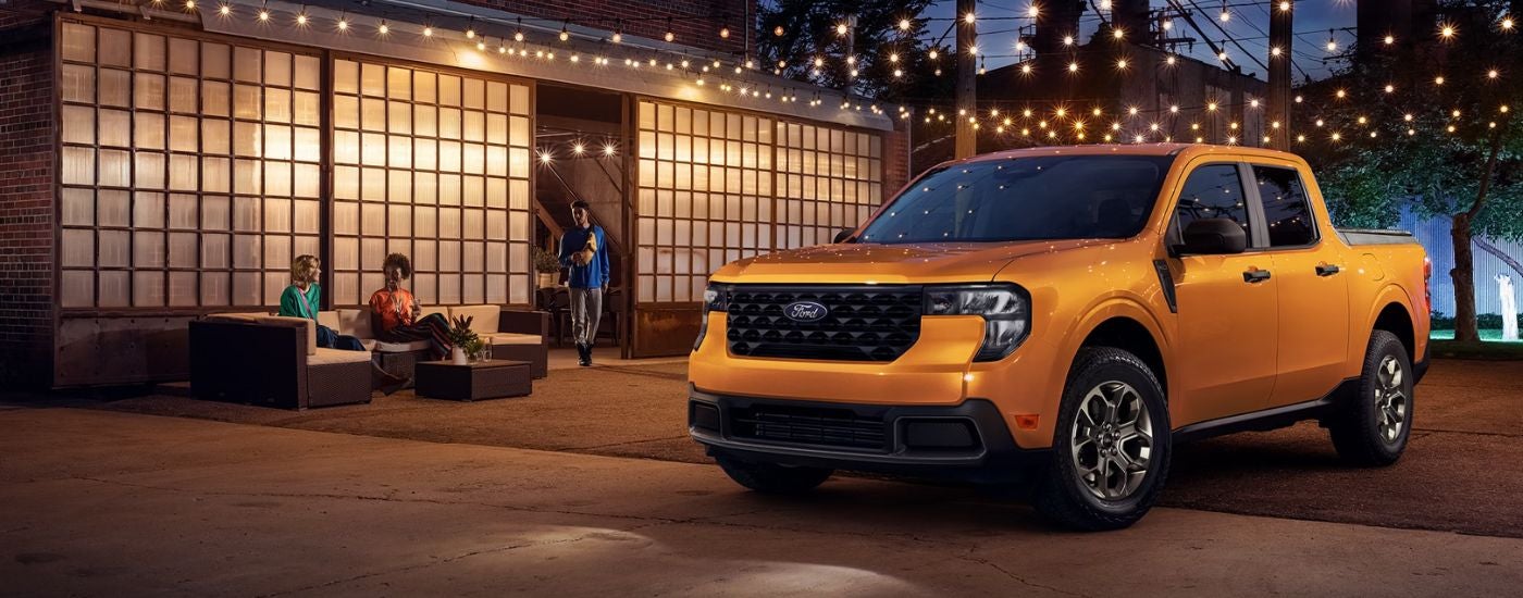 Orange 2026 Ford Maverick parked under string lights.