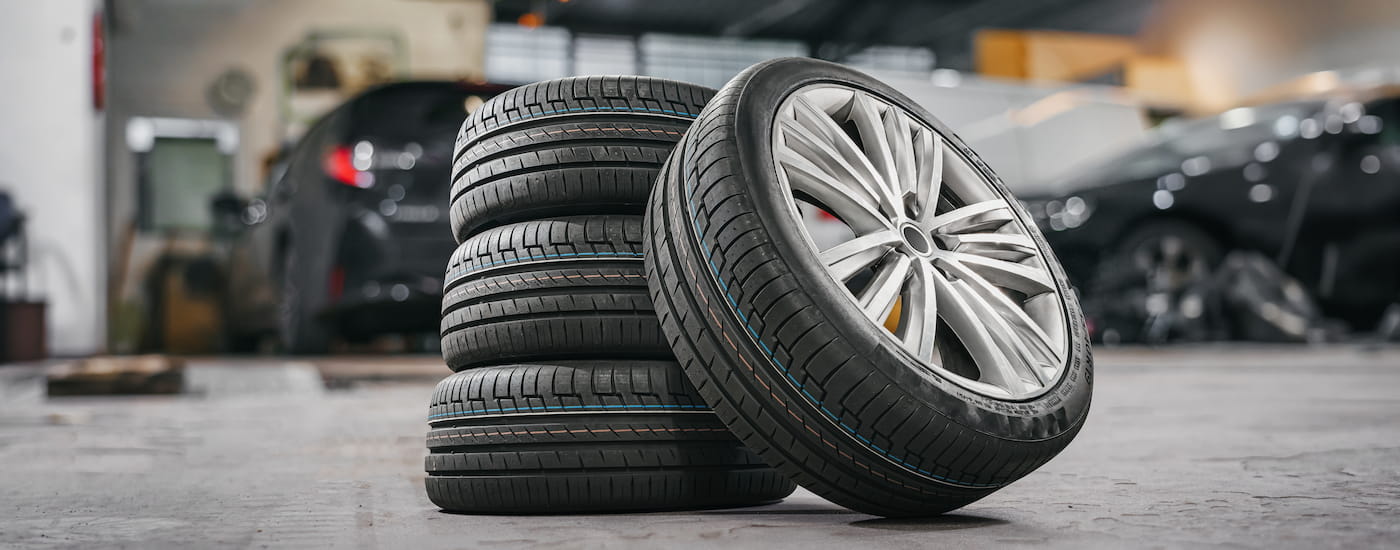 Stack of tires sitting in a tire shop.