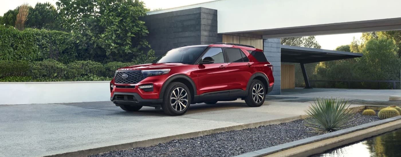 A red 2023 Ford Explorer ST Line parked in a driveway