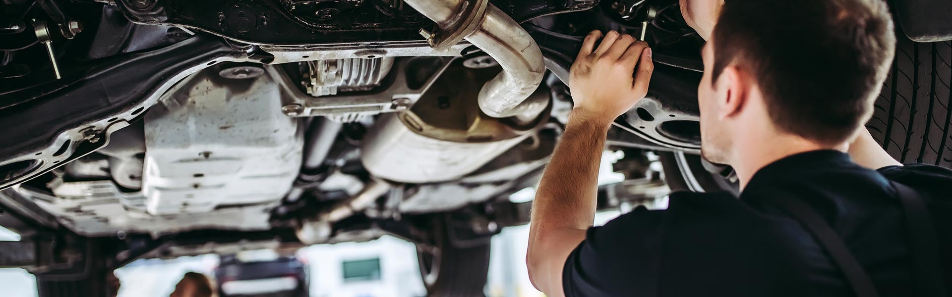 Service Technician Working on a Used Car